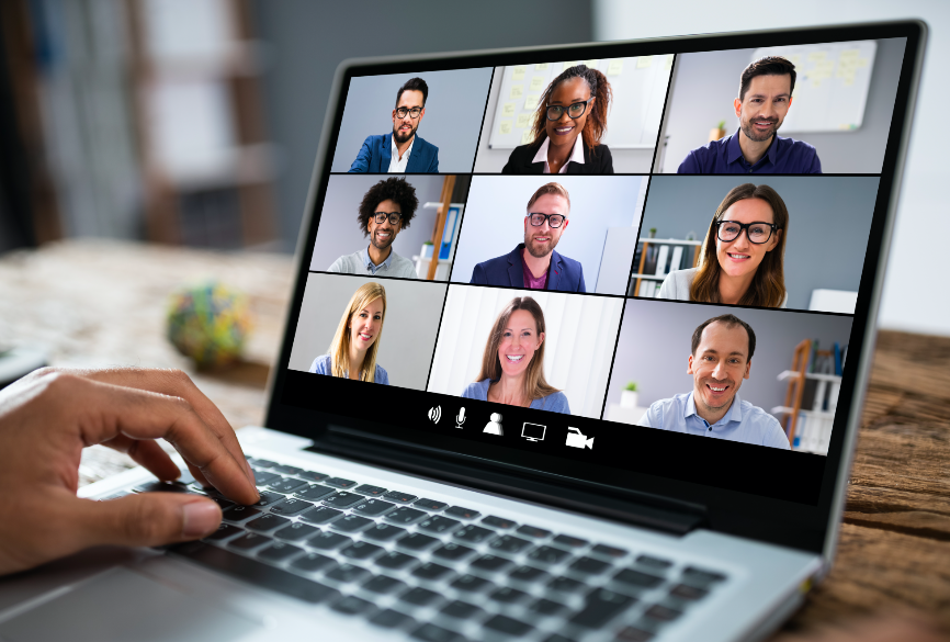 A person video conferencing with few people on the laptop