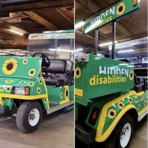 Image of the assistance buggy wrapped in ‘Hidden Disabilities’ branding