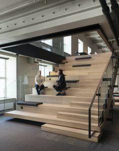 Two women sitting on the stairs talking