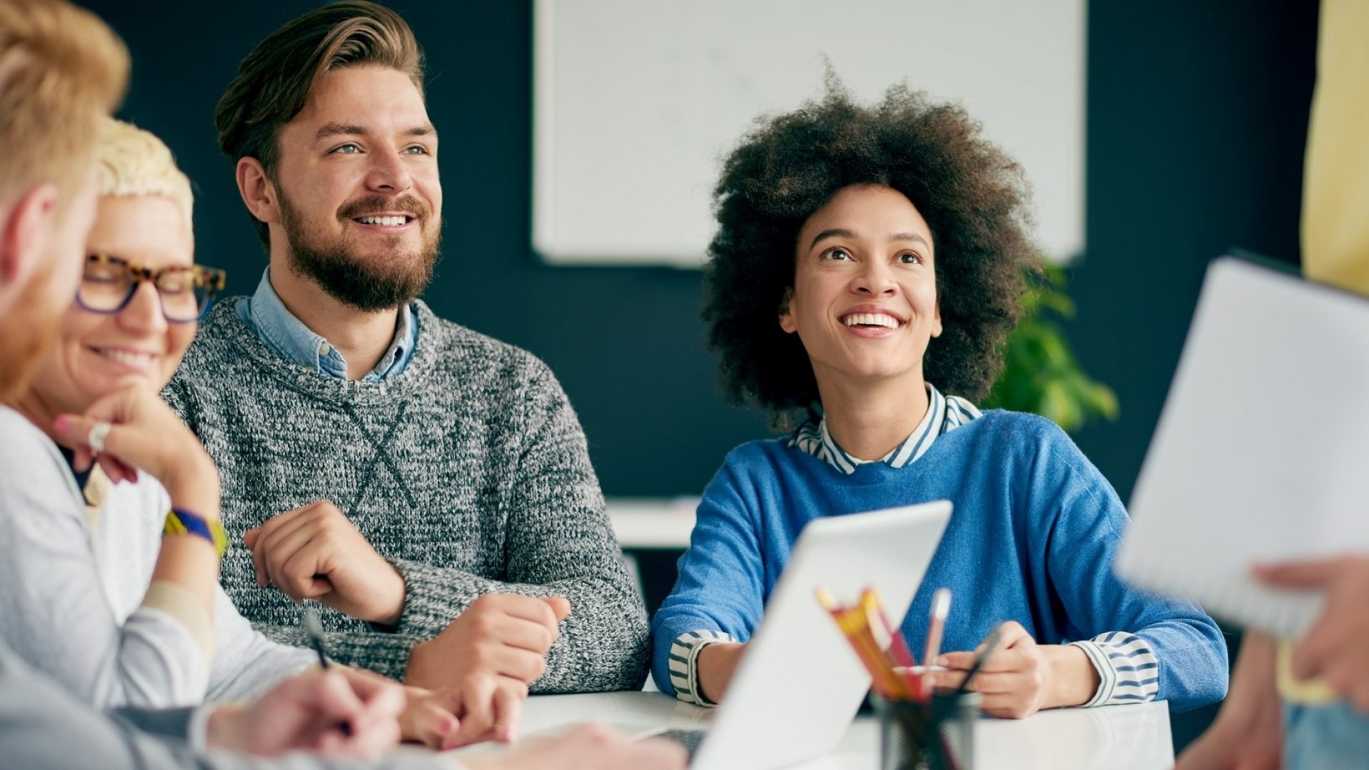 Few people both man and woman smiling at work